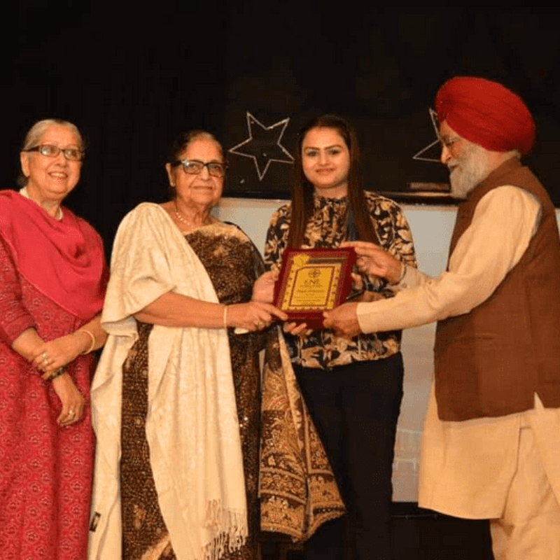 Dr. Amita Abrol honoured on stage at an excellence ceremony