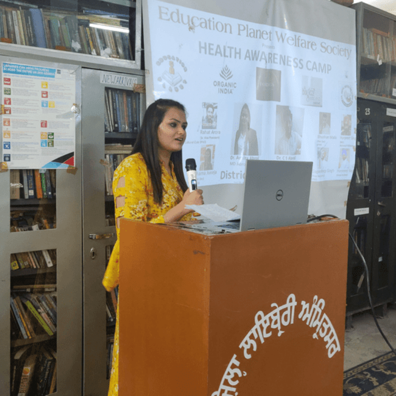 Dr. Amita Abrol speaking at a community Health Awareness Camp