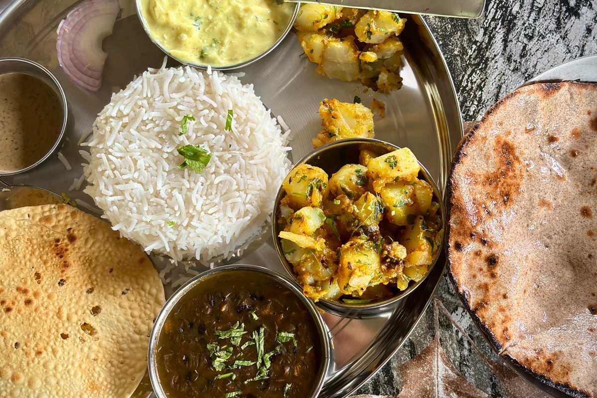 Warm freshly cooked Indian thali with digestive spices to support agni in hypothyroidism