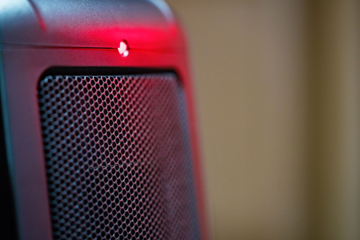 Close-up of an electric room heater with a red light