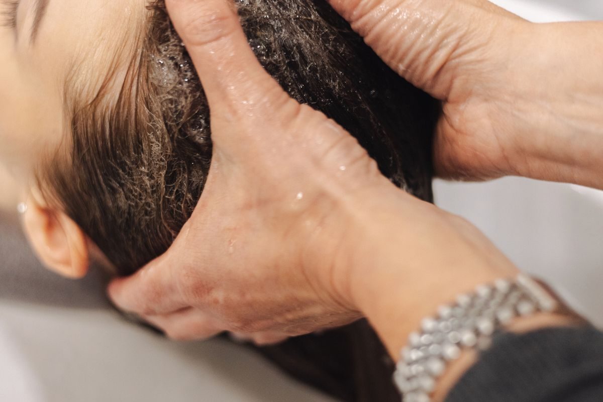 Therapist massaging herbal oil into the scalp during Shiro Abhyanga