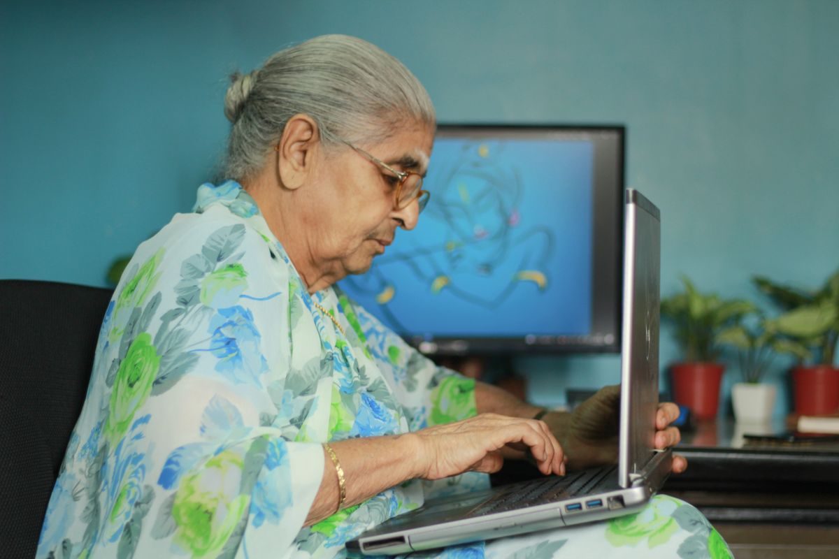 Woman at home on a laptop, ready for an online Ayurvedic consultation