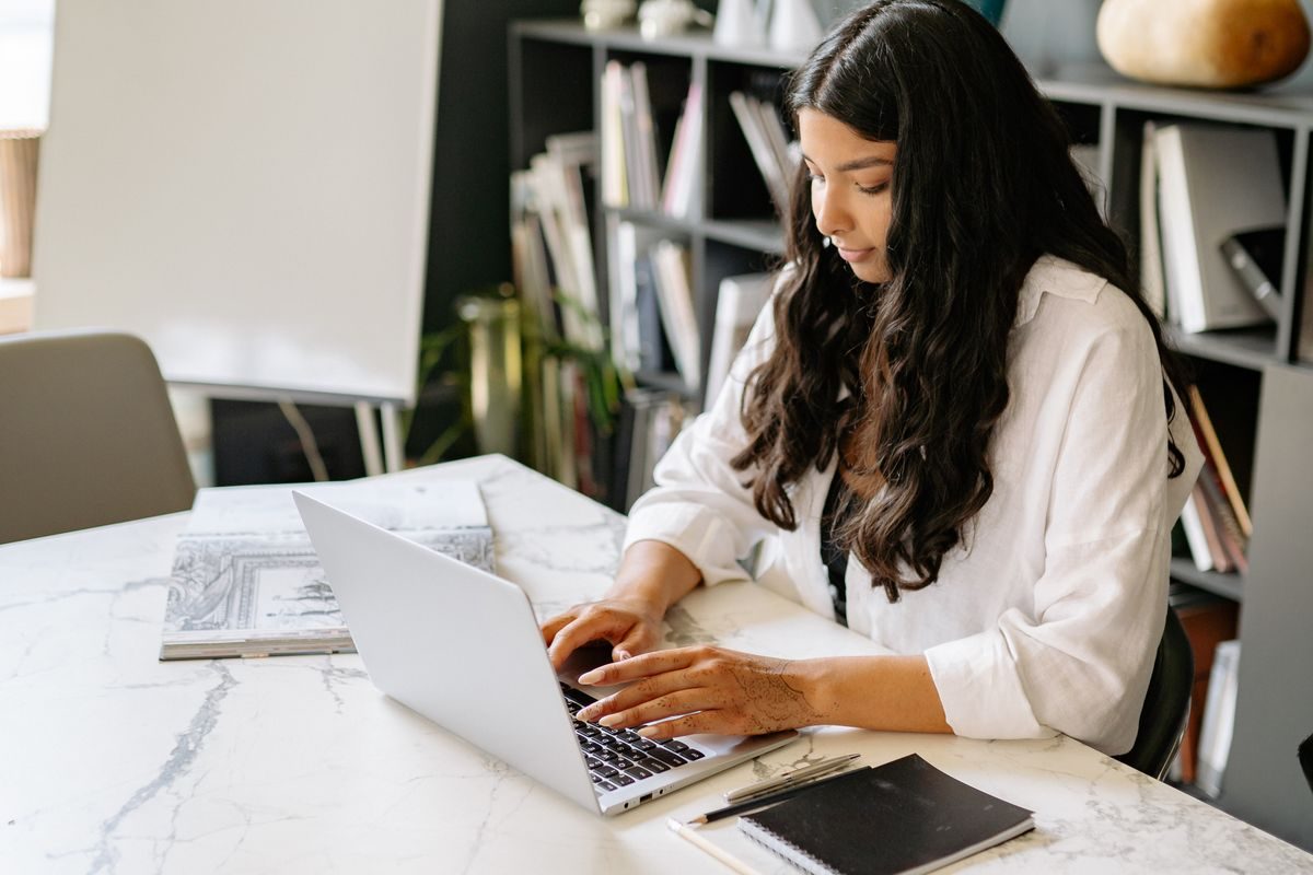Woman on a laptop at home during an online Ayurvedic consultation